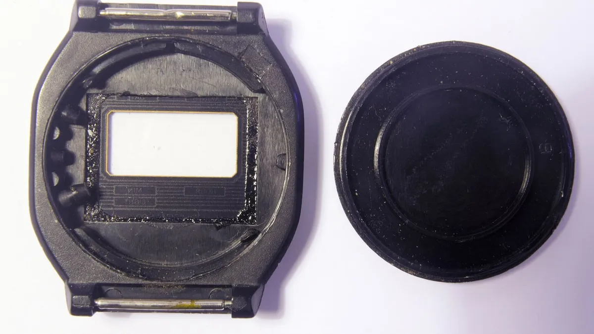 The back of a watch case opened to show the movement inside