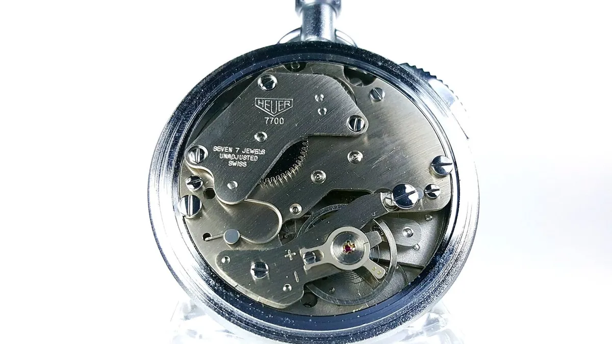 An exposed mechanical watch movement showing its bridges and wheels