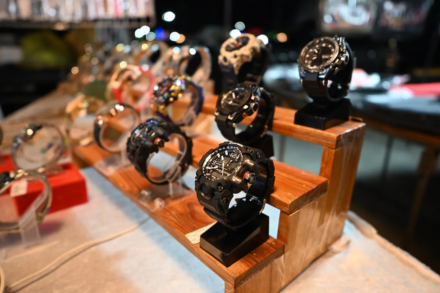 Wristwatches arranged on a wooden display stand