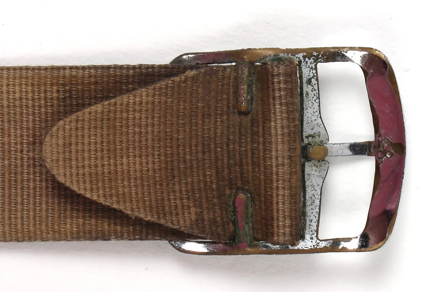 The buckle end of a woven watch strap in close up
