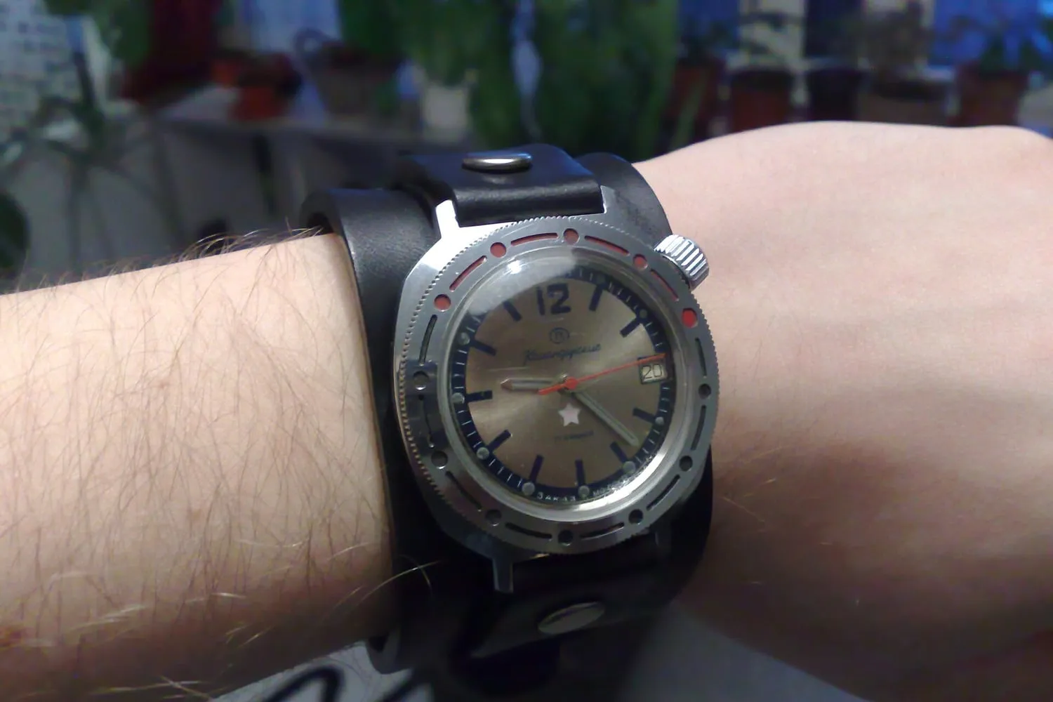 A wristwatch worn on a wrist, photographed from above